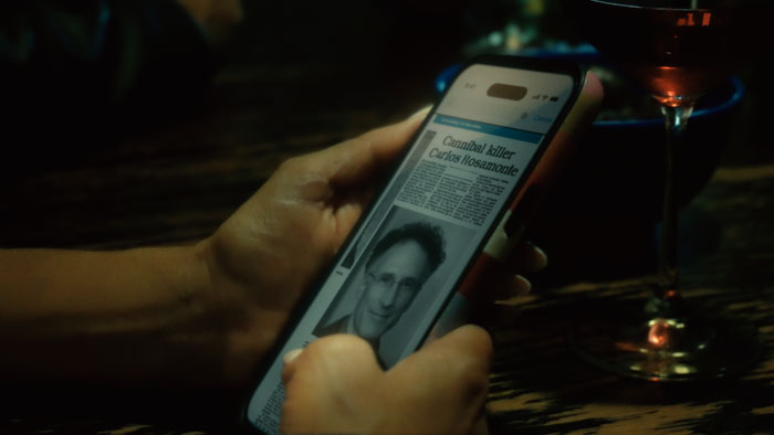 A woman covered in blood speaks on a phone in a dark scene from Night of 5