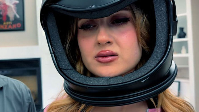 Melina (Sofia Papuashvili) wears a motorcycle helmet during Richard’s strange emotional experiment in One Hour Girlfriend.