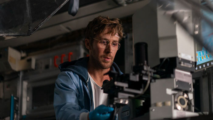 Ryland Grace (Ryan Gosling) analyzing samples under a microscope in Project Hail Mary.
