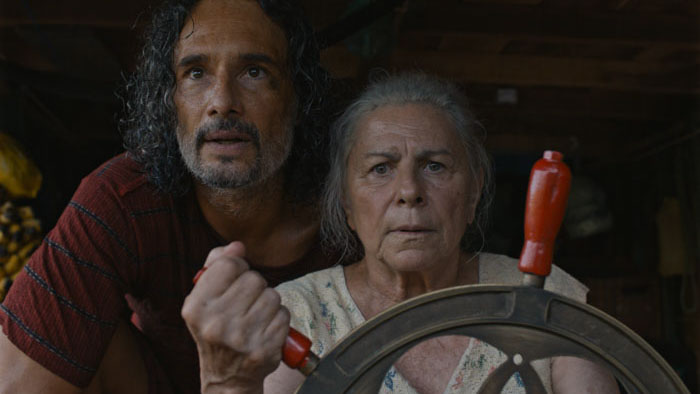 Tereza (Denise Weinberg) and a companion steer a boat in The Blue Trail.
