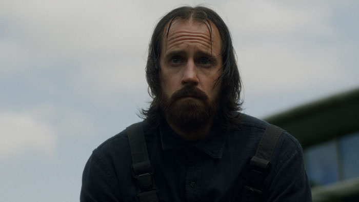 Eddie (Ben Probert) stands outside in The Caretaker.