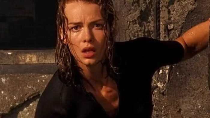Fiona (Saffron Burrows) stands soaked and terrified in The Morrigan.