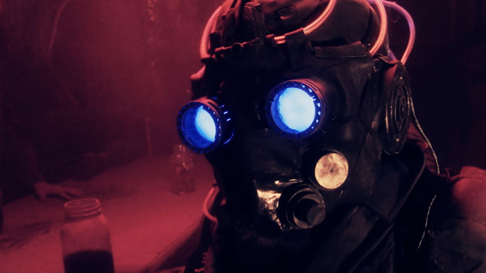 Rhyous (Brendan Guy Murphy) wears a glowing gas mask in Wastelander.