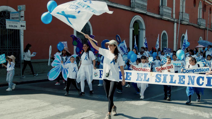Brisa De Angulo marching with supporters during a public advocacy rally in Brisa.