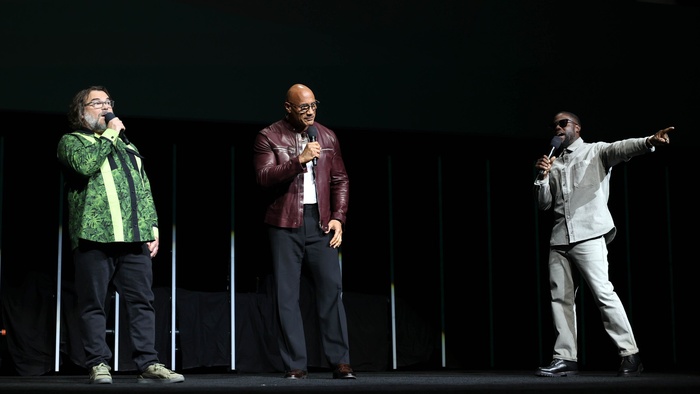 Jack Black, Dwayne Johnson, and Kevin Hart onstage presenting Jumanji: Open World at CinemaCon 2026 in Las Vegas.