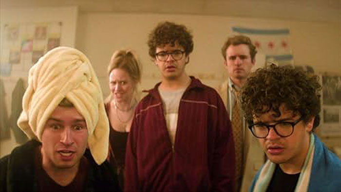 Montgomery (Sean Giambrone), Jack (Gaten Matarazzo), and other students react in shock during a chaotic scene in Pizza Movie.