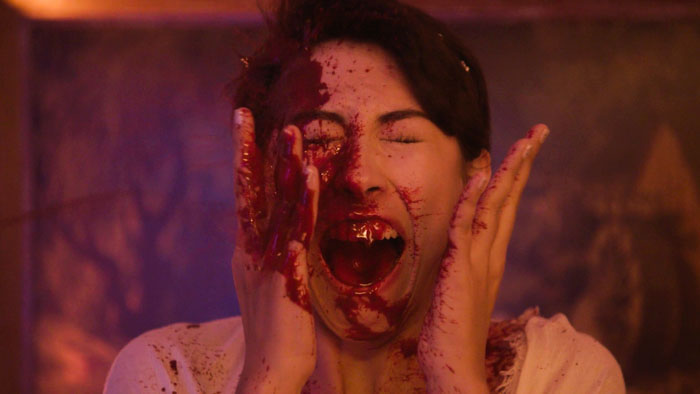 A screaming, blood-soaked party guest in Prom Party Massacre.