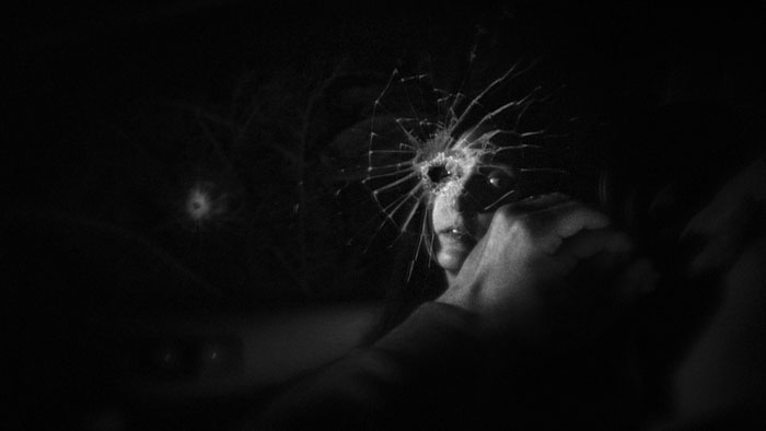 Richard Lukacs seen through a shattered windshield in Sound of the Doldrums. 