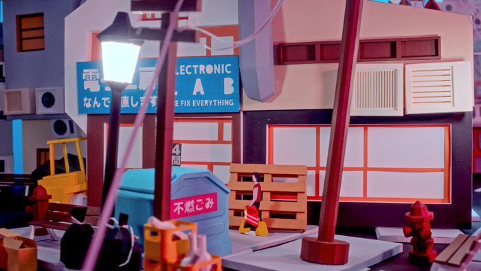 A low-poly paper city street with an electronics repair shop in Spacetime Chronicles.