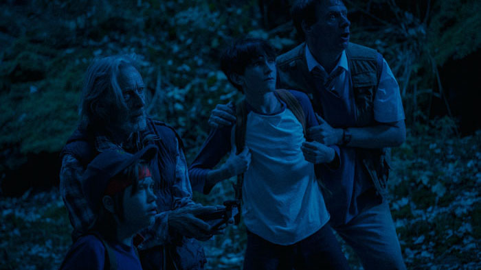 Jack, Benji, Sadie, and Professor Alan search the forest in Stargazers.