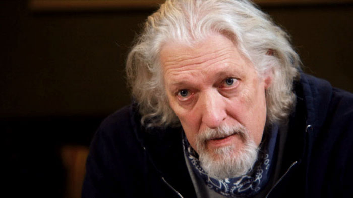 Riz the Director (Clancy Brown) appears in a close-up scene from The Addiction of Hope.