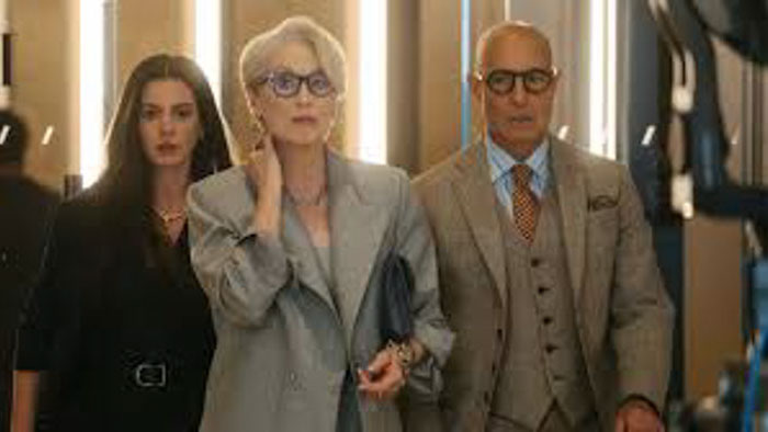 Andy Sachs (Anne Hathaway) and a male colleague discuss fashion in a Runway office closet in The Devil Wears Prada 2.