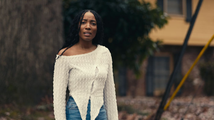Angela Brown (Rachel Brooks) stands outside in The Gospel of Dating.