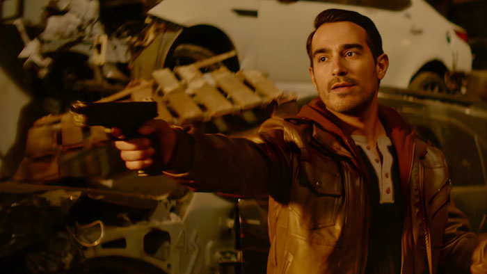 Phil (Jon Oshei) points a gun in The Lonely Crowd.