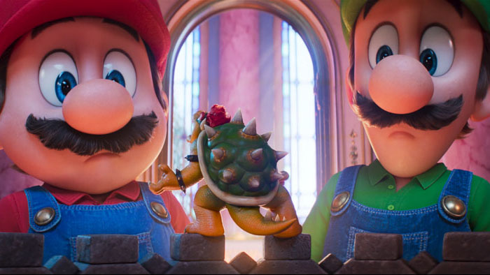 Mario (Chris Pratt) and Luigi (Charlie Day) look down at a miniaturized Bowser (Jack Black) in The Super Mario Galaxy Movie.