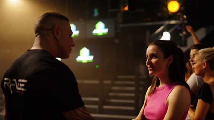 Joey and Ellie face each other in a tense moment inside a nightclub in Cage Rage.