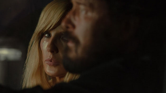 Beth Dutton (Kelly Reilly) looks toward Rip Wheeler (Cole Hauser) in Dutton Ranch.