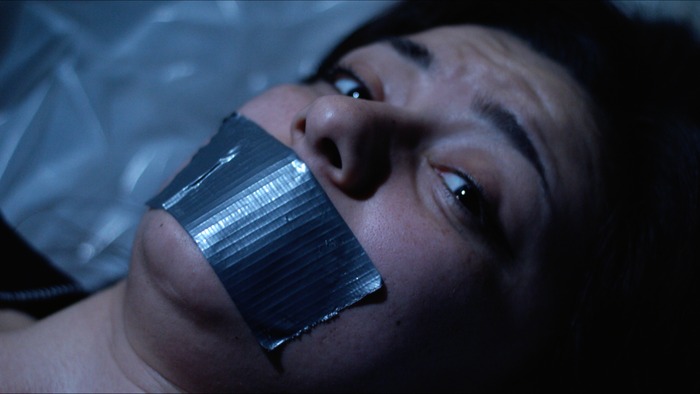 Megan lies bound and gagged in Evil inSight.