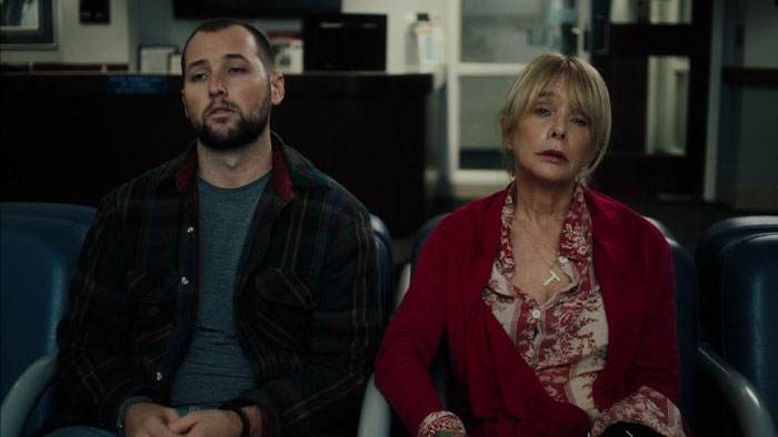 Travis (Chase Joliet) and Evelyn (Rosanna Arquette) sit together at an AA meeting in Grapefruit.