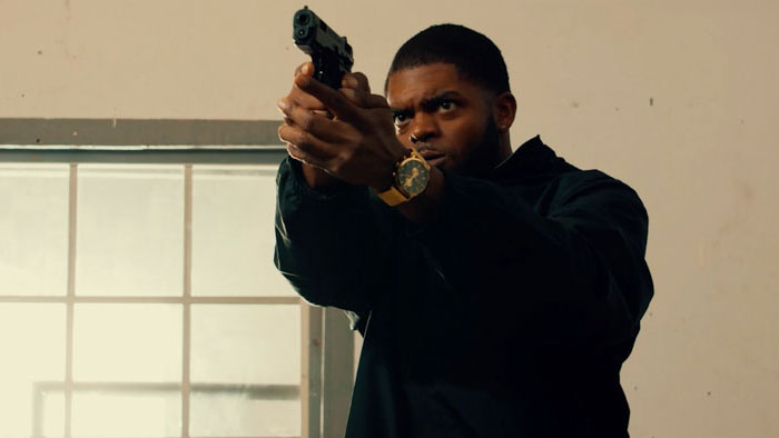 Corey Shaw (Omar Cook) aims a gun in LA Undercover: Against The Code.
