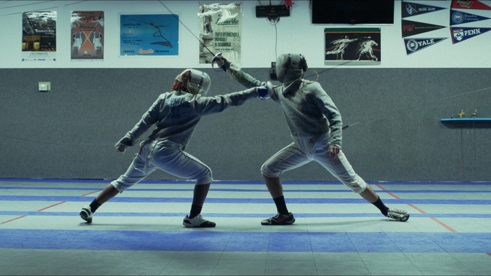 Jaime and Taylor face off in a fencing match at the electronic scoreboard in On Guard.