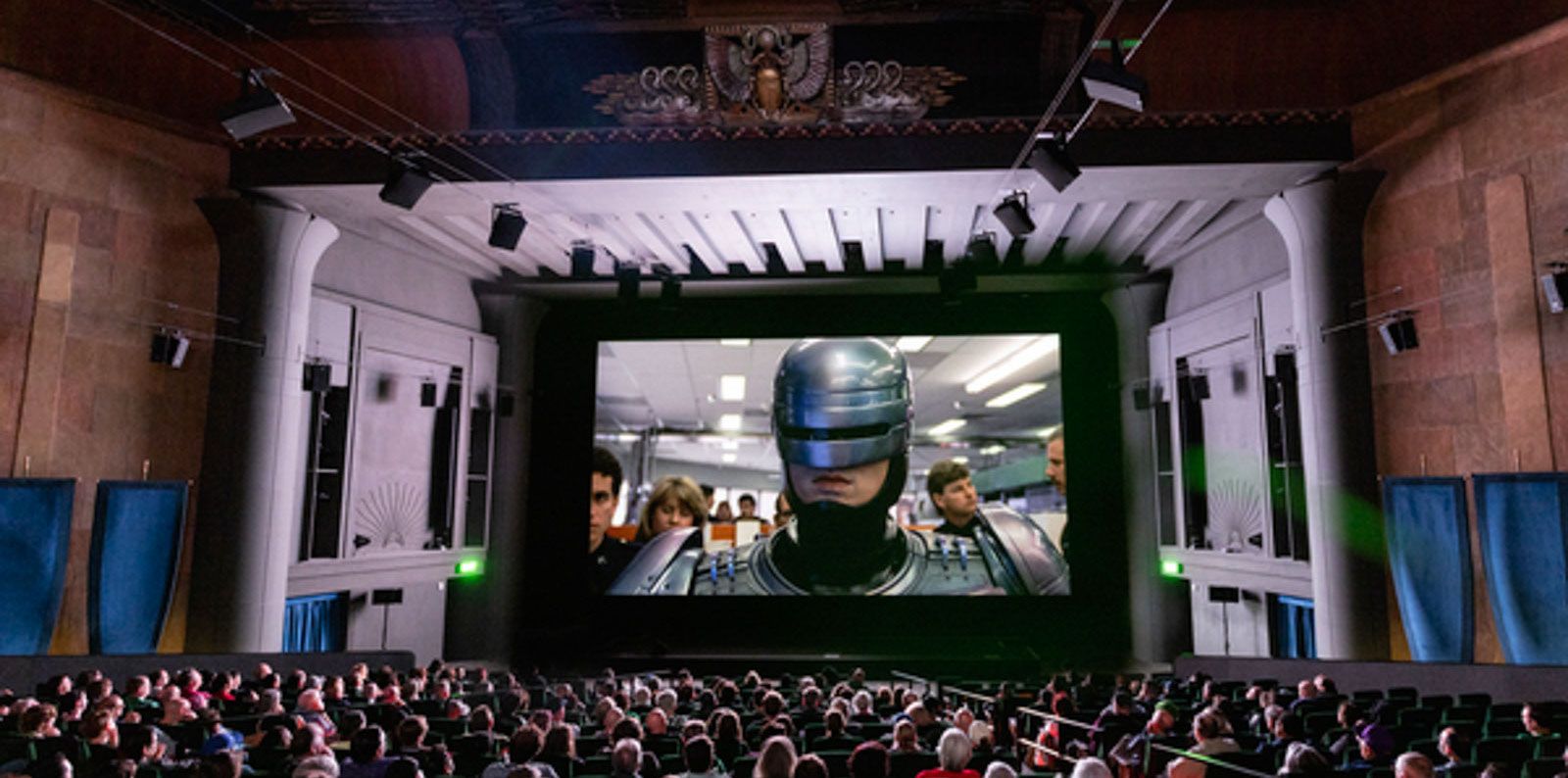 A packed theater watches RoboCop during the TCM Classic Film Festival.