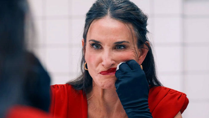 Elisabeth Sparkle (Demi Moore) applies lipstick in The Substance