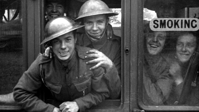 British soldiers laugh from a train window headed to the front lines in the documentary Trains.