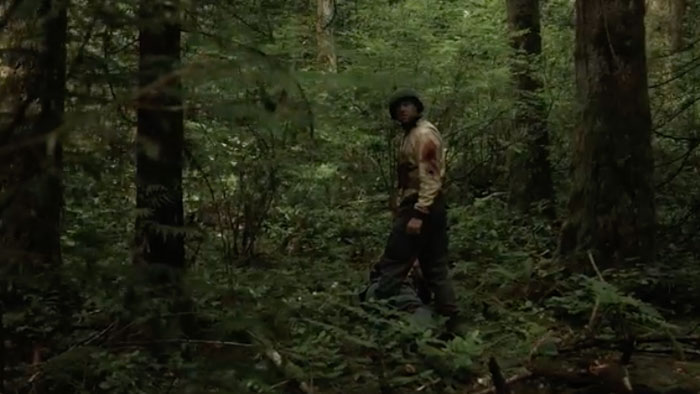 American medic Doc navigates through dense forest terrain in World War Bigfoot.