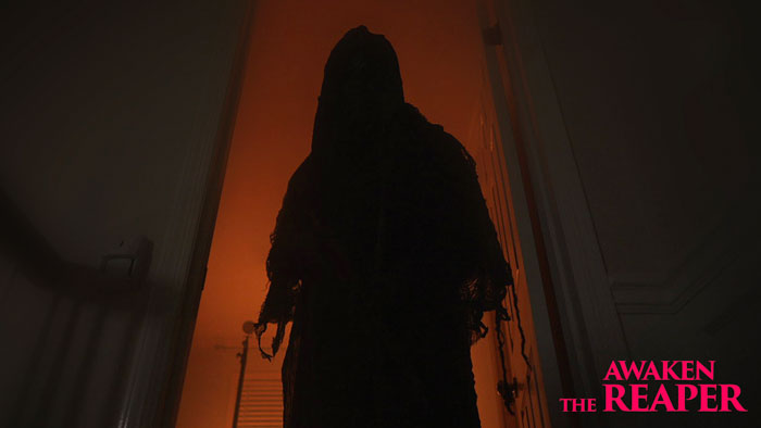 The Reaper stands as a dark silhouette in a glowing orange doorway in Awaken the Reaper.
