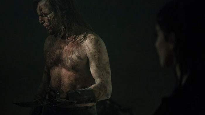 The Blades Man (Lorenzo Lepori), bloodied and feral, holds his blade in Blades in the Darkness.
