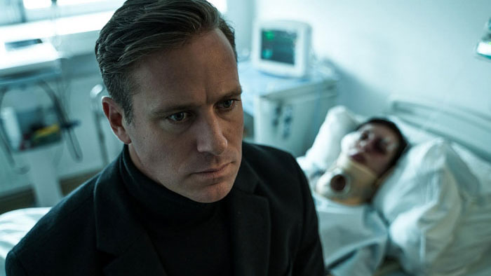 Sanders (Armie Hammer) sits beside an injured young woman in a hospital bed in Citizen Vigilante.