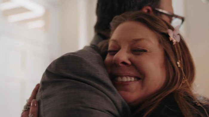 Sunday Thompson (Melissa Clair) smiles while embracing David in Executive Zen.