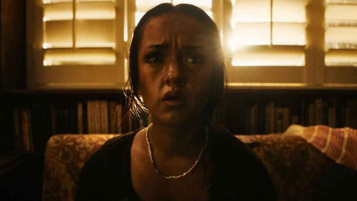 Sarah (Jyllian Petrie) stares in terror from a dimly lit room in Morbid Sight.