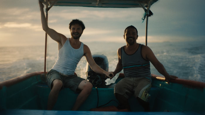 Trent (Spencer Bang) and the Fisherman (Mario Chacón) ride together on a boat in Pescador.