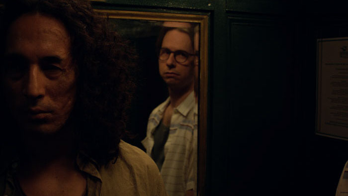 El Quemado (David Gaete) and Udo Berger (Dan Beirne) in a hotel elevator in Summer War.