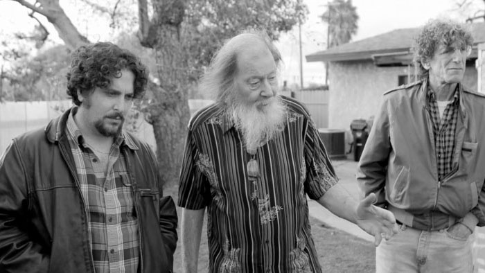 Sammy (Oliver Cooper), Burt (Burt Berger), and Steve (Steven Levy) walk outside in Burt.