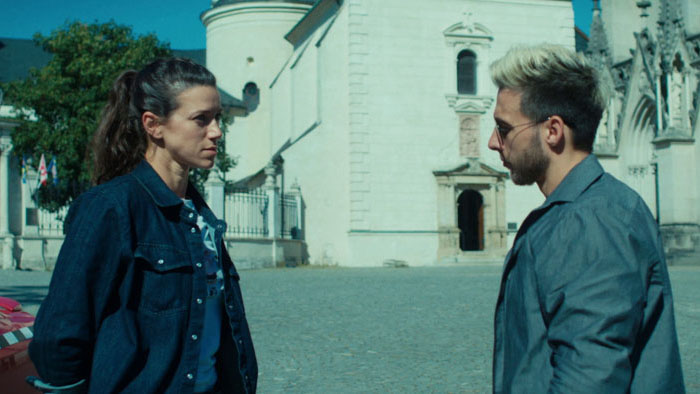 Sára (Andrea Mohylová) confronts Bob (Albert Čuba) outside a church in Disconnected.