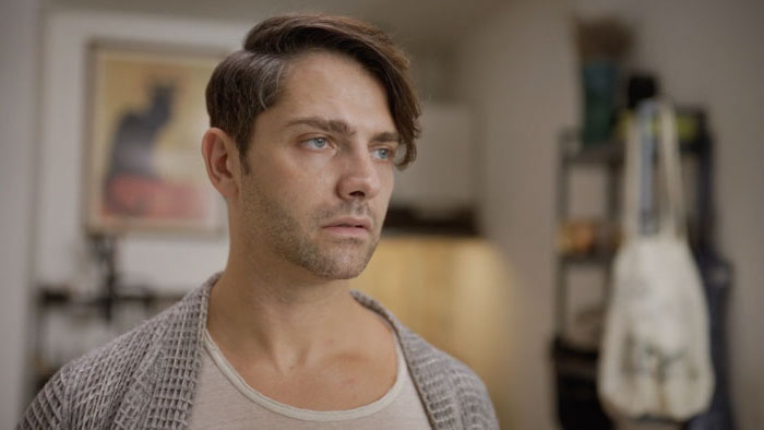 Roman (Michael Raver) stares off with a somber expression in Elsewhere.