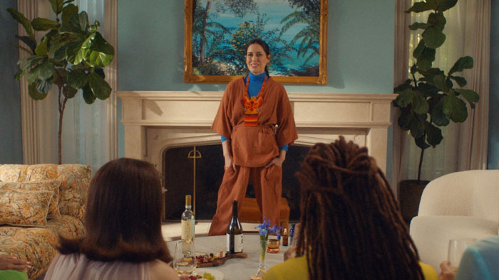 Marla (Sheila Carrasco) leads a pelvic floor session in a pastel living room in Floored.