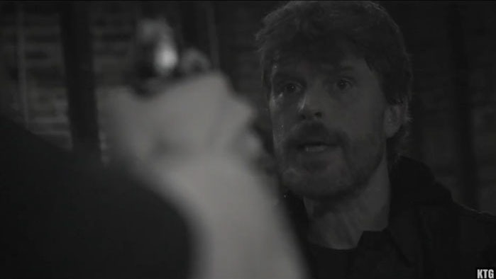 Older Jake (Joseph O’Connor) confronts someone at gunpoint in Kill the Girl.