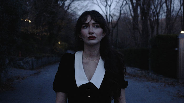 Pretty (Melisa Kihtir) walking outside at dusk in Pretty.