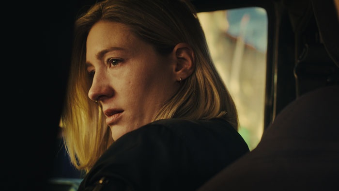 Mara (Mary Pursell) looks back from inside a vehicle in What Only Cicadas See.