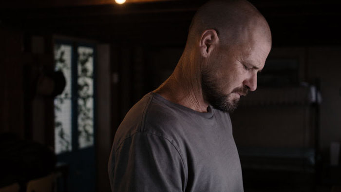 Ben (Nathan Phillips) stands alone in a dim beach shack in 13th Summer.