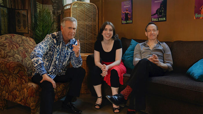 Bruce Campbell sits with two co-stars on the set of Ernie & Emma.