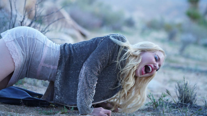 Lola (Chloe Cherry) lies distressed in the desert in Find Your Friends.