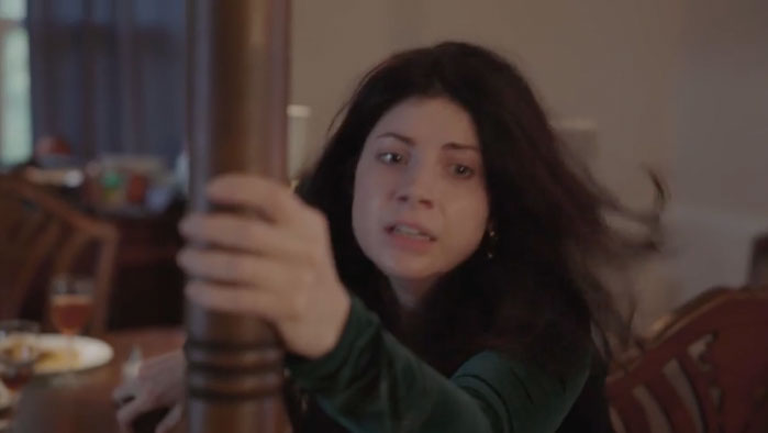 Mia (KateLynn E. Newberry) grabs a wooden post at the dinner table in Forever Mia.
