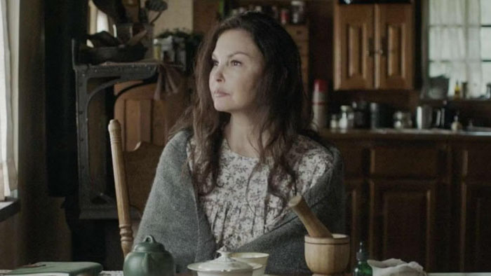Lee (Ashley Judd) sits at the kitchen table wrapped in a shawl in Lazareth.