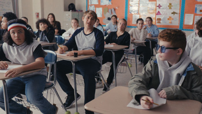 Middle school students sit at their desks during a classroom scene in Lunch Box.