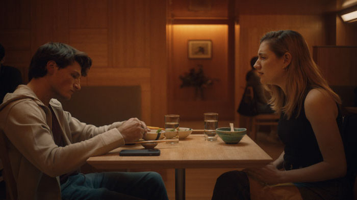Isabel (Isabel Hagen) talks with a dinner companion at a Japanese restaurant in On a String.